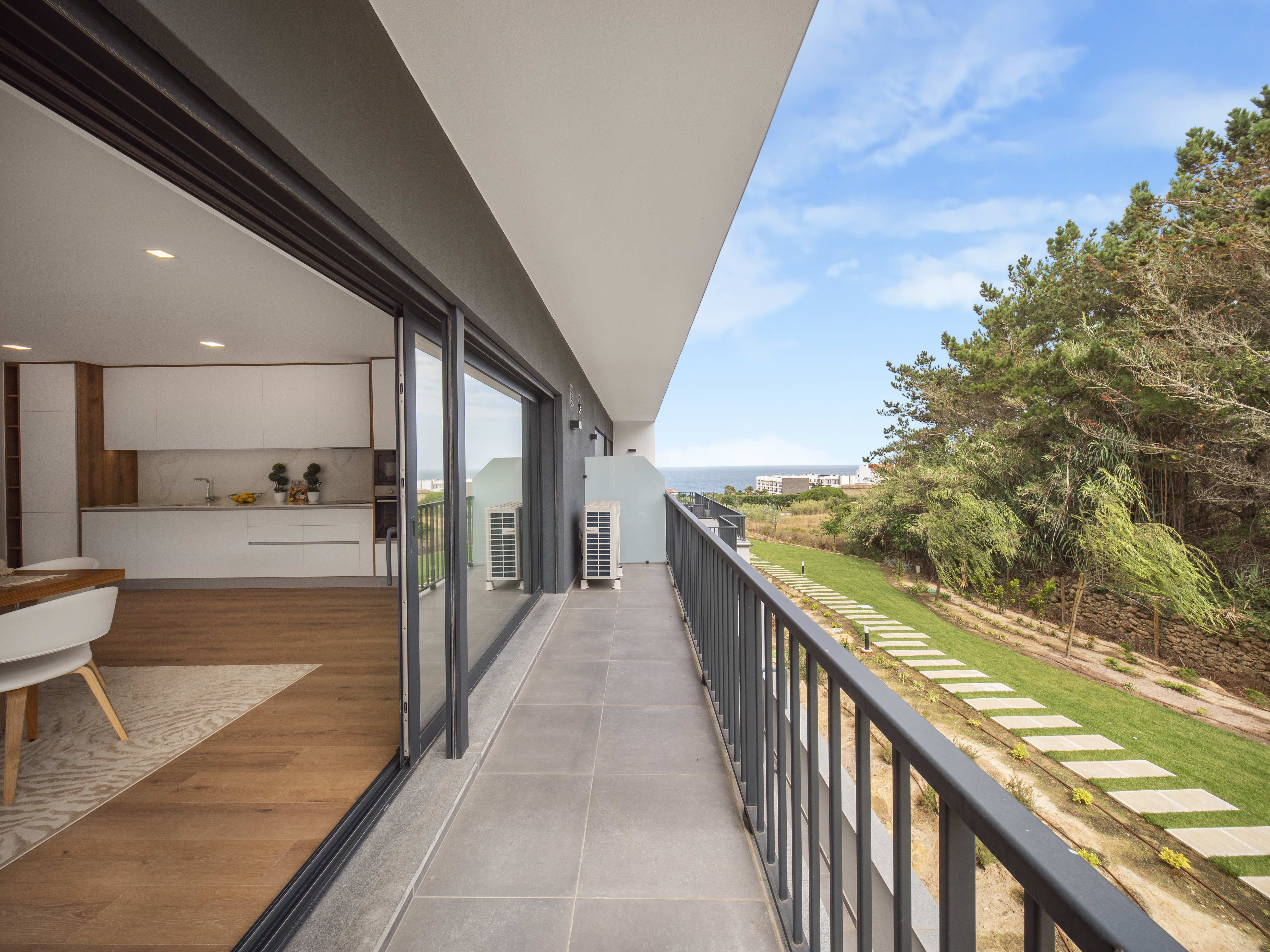Balcony of a new apartment overlooking a garden and the sea